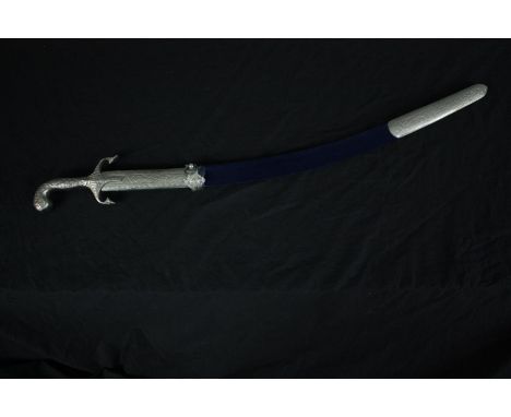 A ceremonial Indian sword with a velvet covered scabbard. The clasp is loose and will need repairing. L.75 cm. 