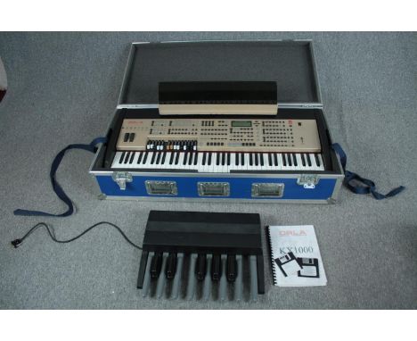 The Orla KX1000 organ complete with all its pedals and manual. In sturdy inflight case. L.120 W.54 cm. 