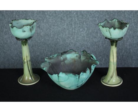 A pair of art pottery candle holders and a bowl. In the shape of cabbage leaves. Signed by the maker on the base. H.26cm. (la