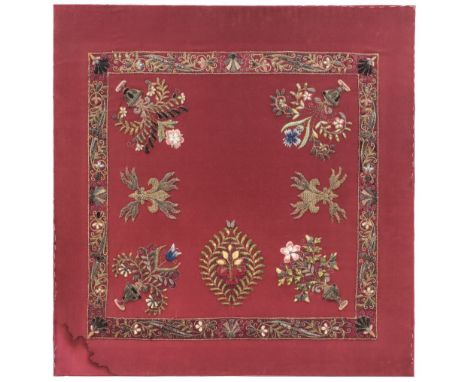 * Embroidered panel. A silk panel of 18th century appliquéd embroidered metalwork motifs, 7 expertly stitched motifs within a