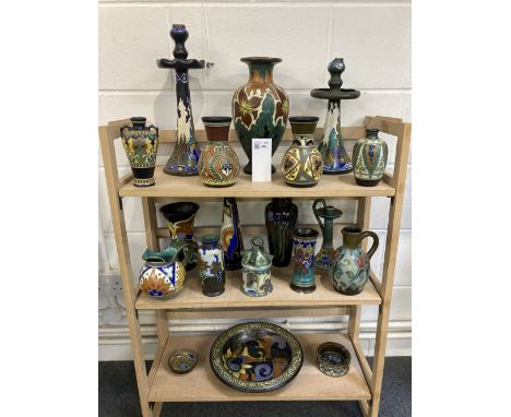 * Gouda Pottery. A collection of Gouda pottery, including a large candlestick circa 1928, polychrome floral decoration on a b