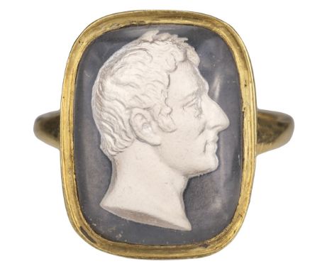 * Duke of Wellington. A Victorian yellow metal gents mourning ring circa 1852, set with a convex glass sulphide panel with bu