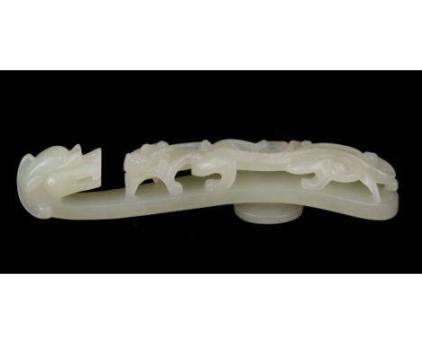 * Jade. A Chinese jade belt hook, pale celadon carved as a dragon and chilong, 9.5 cm long QTY: (1)