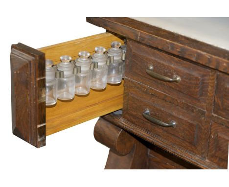 * Desk. An Edwardian oak clerks desk, the upper section with mirror flanked by two cupboards each with a two tone green glass