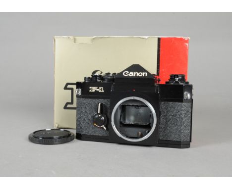 A Canon F-1n SLR Body, black, serial no 661211, eye-level viewfinder, split-image and microprism ring viewing screen, shutter