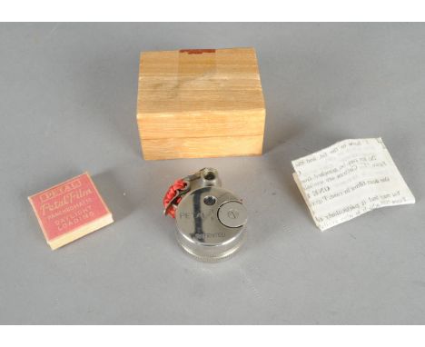 A Sakura Petal Sub-Miniature Camera, round body, G, with a packet of Petal Panchromatic Film and sheet of instructions, all i