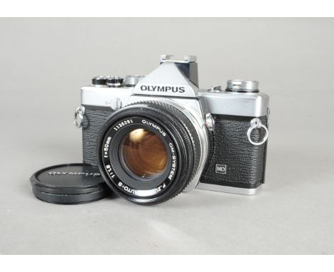 An Olympus OM-1N MD SLR Camera chrome, serial no 1652460, shutter working, body VG, scuffing ends of top plate and base, pain