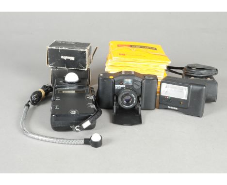 A Minox 35 GT Compact Camera and Sundry Accessories, black, serial no 5392801, with Color-Minotar 35mm f/2.8 lens, body F, we