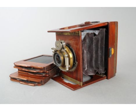 A Shew Xit Mahogany Gate Strut Folding Camera, quarter plate, with an Aldis lens, focusing lever, Bausch &amp; Lomb shutter, 