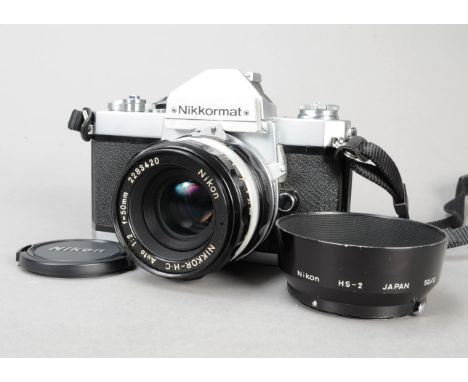 A Nikon Nikkormat FT2 SLR Camera, chrome, serial no 5438442, with a Nikkor-H C 50mm f/2 lens with hood, serial no 2283420, sh