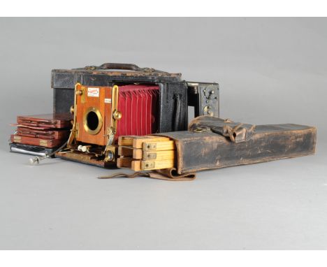 A Sanderson Regular Hand &amp; Stand Half Plate Camera, serial no 11437, red bellows, no lens, focal plane back, dark slides 