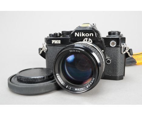 A Nikon FM2n SLR Camera, black, N 7320106, serial no 7320106, shutter working, body G-VG, scratch to shutter speed dial, with