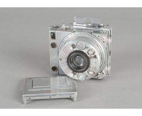 A Compass 24 x 36mm Rangefinder Camera, serial no 1665, with a 35mm f/3.5 lens, together with a plate back, condition F-G, ag