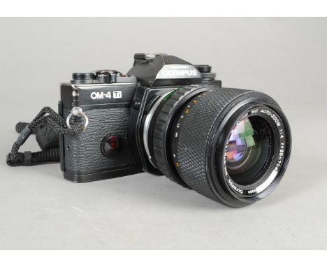 An Olympus OM-4Ti SLR Camera, black, serial no 1169896, shutter working, condition G, paint loss on bottom plate, with a OM Z