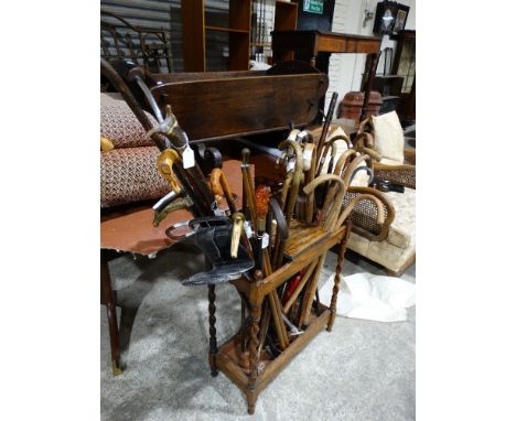 A Polished Oak Stick Stand Containing A Good Quantity Of Mixed Canes & Sticks