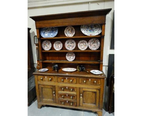 An Antique Oak & Mahogany Welsh Dresser, Having A Three Shelf Rack The Base Having Two Side Cupboards With Bank Of Central Dr
