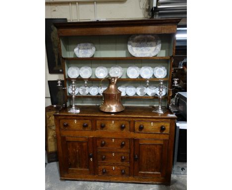An Antique Oak Anglesey Dresser, Having A Three Shelf Rack The Base Having Two Side Cupboards With Central False & Real Drawe
