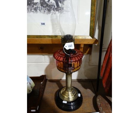 A Victorian Circular Based Brass Column Oil Lamp With Ruby Tinted Reservoir