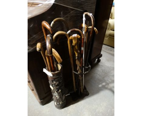 A Cast Iron Stick Stand & Sticks Together With A Bamboo Stick Stand & Sticks