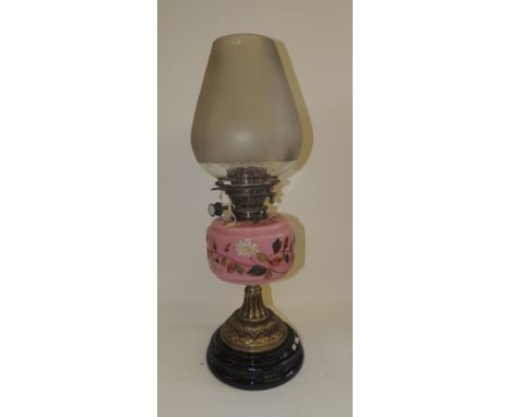 An Edwardian oil lamp fitted with Hinks's Duplex burner, pink glass reservoir painted with flowers, on brass pedestal and bla