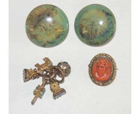 A pair of large, green, glazed "RUSKIN" buttons, small group of seals including a watch key set with two ceramic flower heads