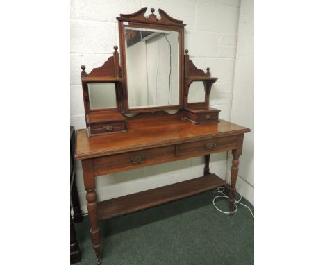 An Edwardian walnut dressing table with jewellery drawers, 2 frieze drawers and lower shelf 122cm wide. 