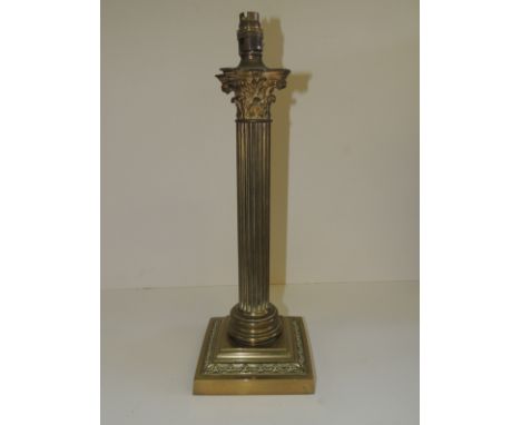 An early 20th Century brass Corinthian column table lamp with weighted base, 40.5cms high not including lamp fitting