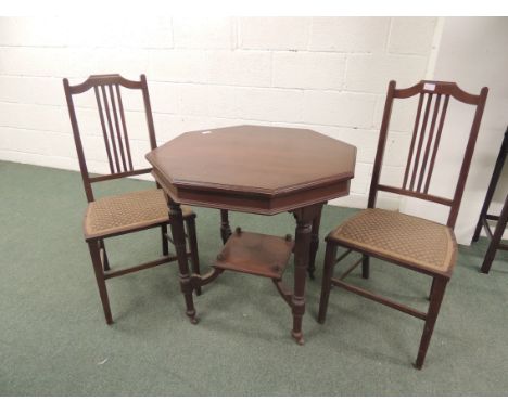 An Edwardian mahogany octagonal table on four turned and fluted supports, with lower tier, on original ceramic casters 75cm w