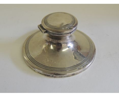 A silver capstan inkwell, hallmarked for Birmingham 1917, liner missing, weighted base. 