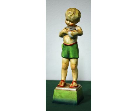A Royal Worcester porcelain figurine: "Friday's Child" is loving and giving. Depicting a boy holding a kitten and bowl. 17cm 