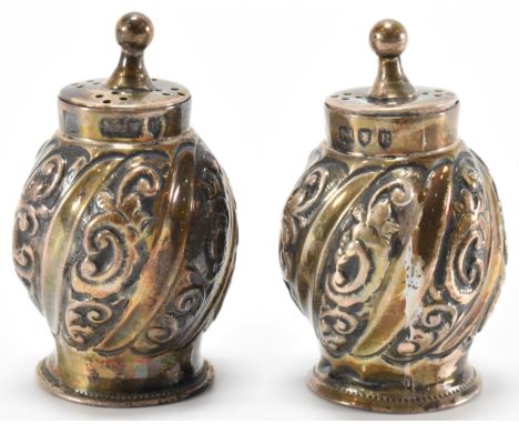 A pair of 19th Century Victorian Henry Wilkinson &amp; Co silver hallmarked pepperette cruets having repousse scrolled decora