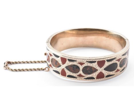A 19th Century Victorian Scottish 9ct gold bangle bracelet being set throughout with coloured agate specimen stones with engr