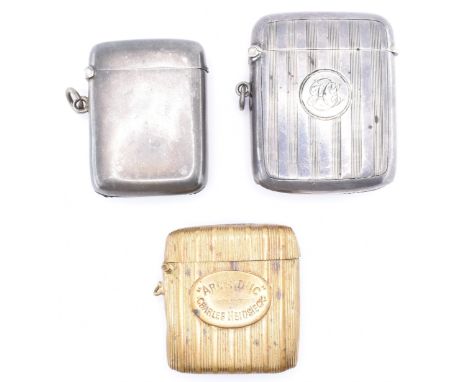A pair of hallmarked silver vesta cases to include a vesta case with engine turned decoration with engraved initials to a cen
