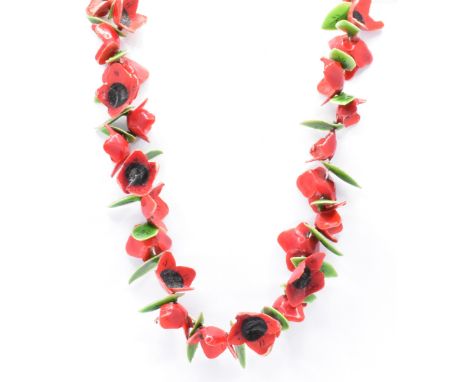 A 1930s enamel laminate poppy collar necklace. The necklace strung with poppy flowers and foliates&nbsp; united by spring hoo