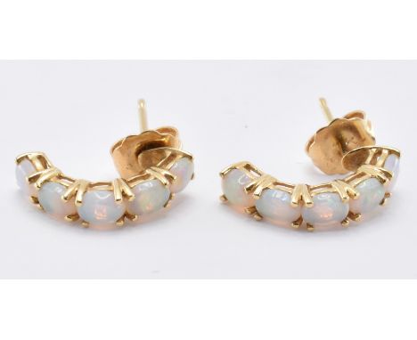 A pair of 18ct gold and opal half hoop stud earrings being set with five opal cabochons. Marked 750 to the posts. Weight 1.8g