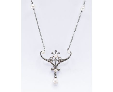 A 19th Century Victorian silver, diamond and pearl pendant necklace. The necklace having a pendant of scrolled wishbone form 