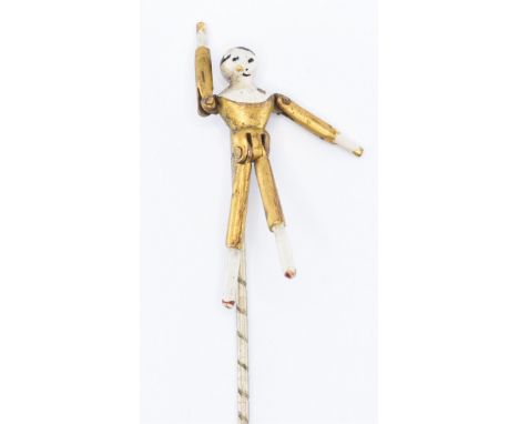 A 19th Century Victorian white metal stick pin having an articulated doll mounted finial. The doll having hinged limbs with e