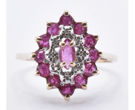 A 9ct gold ruby and diamond cluster ring. The ring having a central marquise cut stone surrounded by a row of diamond chips w