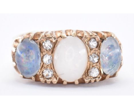 A hallmarked 9ct gold ring and opal ring. The ring set with three opal doublets with six round cut white accent stones. Hallm