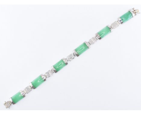 A Chinese jade and silver panel bracelet having six green jade panels united by silver pierced character mark links. The brac
