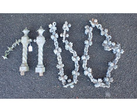 A VICTORIAN ARCHITECTURAL CHAIN AND TWO STANCHIONS galvanised iron, the chain links of floral form, the pillars spiral with s