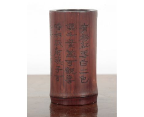 A CHINESE BAMBOO BRUSH POT carved with a seated figure in a rectangular panel with re-entrant corners, the reverse with four 