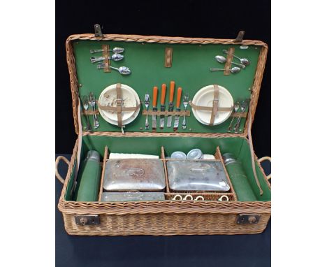 A VINTAGE WICKER-CASED PICNIC SET with Bandalasta Ware cups saucers and plates, two flasks, ceramic boxes etc (general wear)
