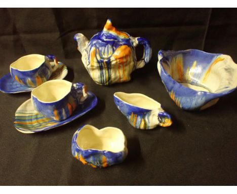 CLARICE CLIFF: A RARE 'LE BON DIEU' CABARET SET 'and matching bowl, of naturalistic tree trunk shape with dripped coloured gl