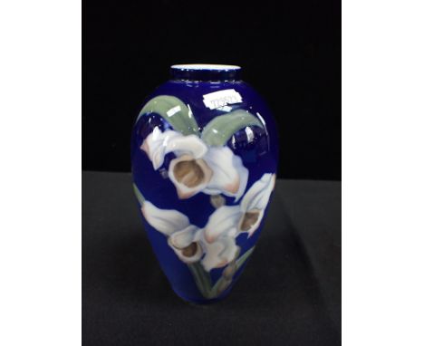 A ROYAL COPENHAGEN PORCELAIN VASE decorated with irises on a blue ground, 18cm high