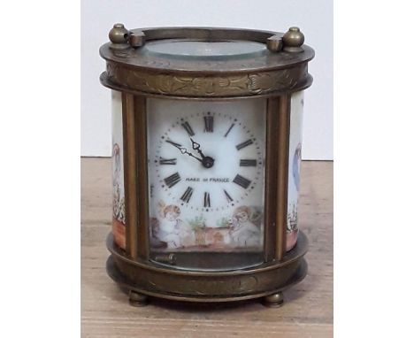 A reproduction French miniature carriage clock, with hand painted porcelain panels. 