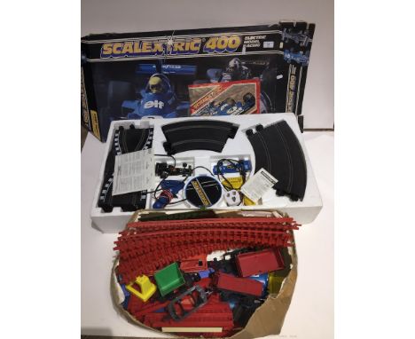 scalextric 400 set and a box containing a vintage plastic train set 