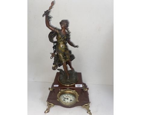A French art nouveau mantle clock signed with key &amp; pendulum, height 60cm. 