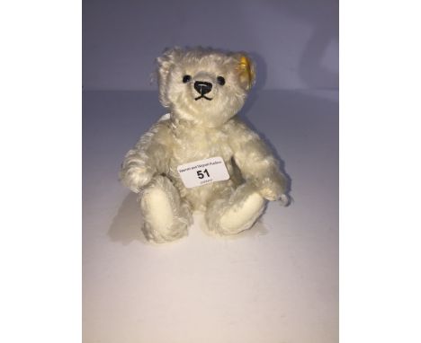 A Steiff bear, 028496, mohair, Little Angel with a metal star on tip of wing. Seated, height approx 14cm. 