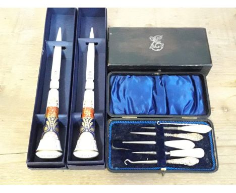 A mixed lot comprising two Royal Worcester Queen's Golden Jubilee letter openers, an ebony box and a manicure set. 
